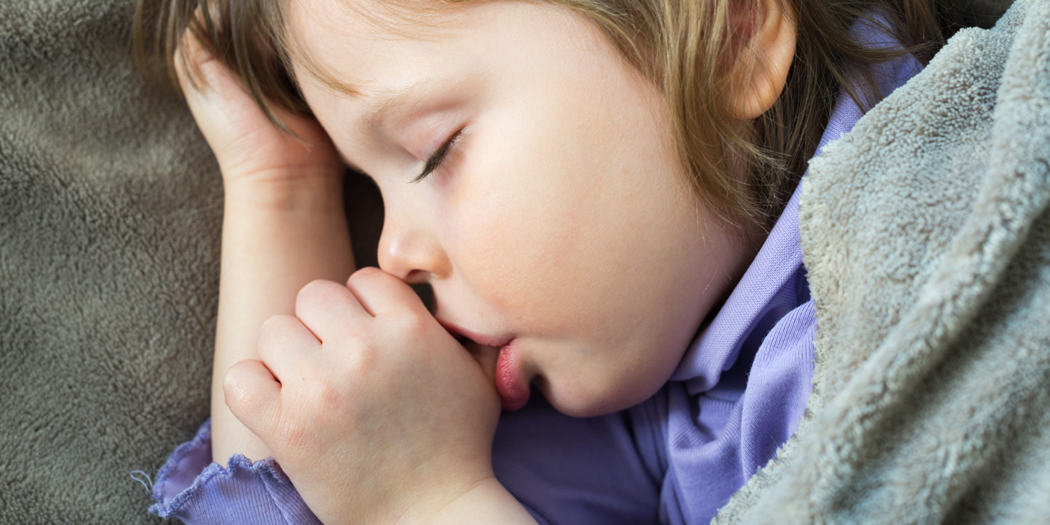 Sleeping little cute baby sucking thumb