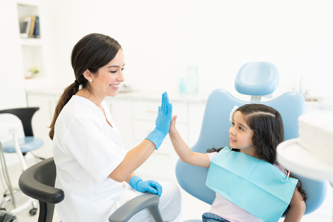 Smiling Dentist And Patient High Fiving