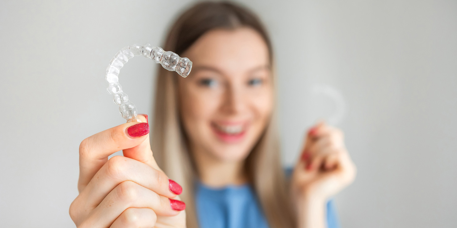 Female hand holding Invisalign